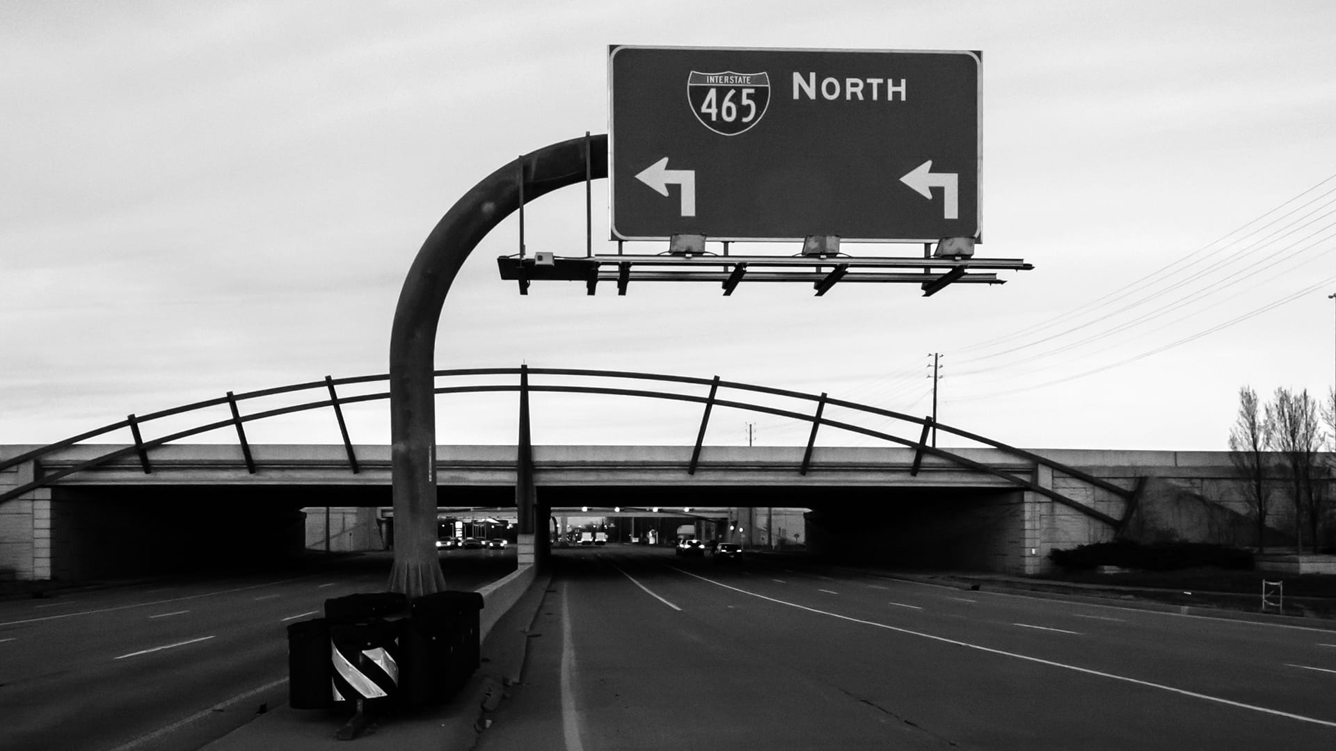 Interstate 465 North overhead sign mounted on a curved cantilever gantry above highway — James H Drew Corporation sign structure installation